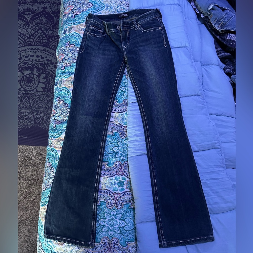 Low cut jeans jeans from early 2000s that have been packed away in closet.